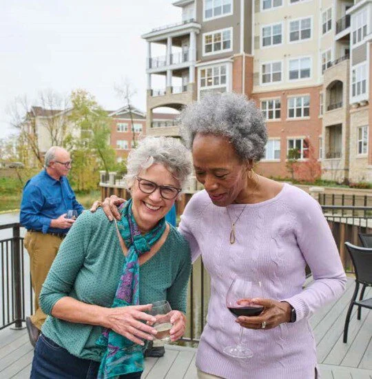 2 women outside with wine laughing
