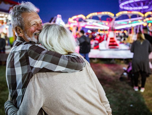 man hugging woman at a fair