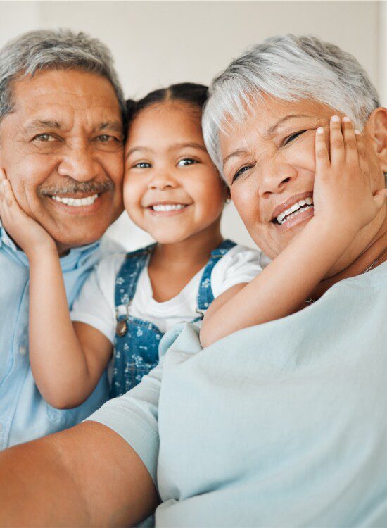 littl;e girl with her hands on the cheeks on and older man and woman